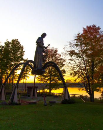 St. Baraga Shrine Statue at sunset on Keewenaw Bay. Baraga Michigan